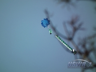 This water rocket is shown using the parachute made in this tutorial for recovery.