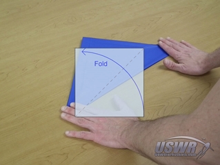 The third fold takes the bottom right corner and folds it diagonally to meet the top left corner.