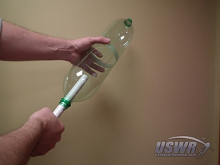 Slide a straight and true launch tube, pipe, or broom handle through the two bottle mouths.