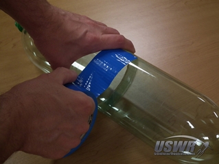 Center the Duct Tape along the joint and dispense the tape around the circumference of the bottles.