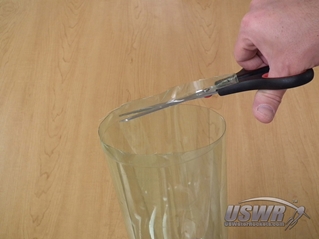 Cut the bottle along the cut line. It his easier if you cut on the side away from your body, not on the closer side.