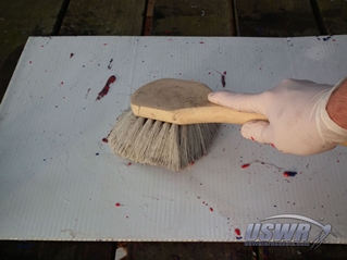 Some brands of stripper require the use of a brush to get all of the printing off.