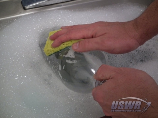Scrub the bottle in the bath.