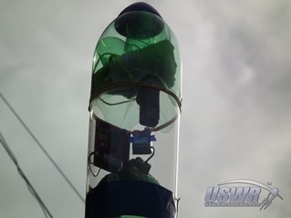 The deploy system can be mounted to the top of the rocket using tape or any suitable method.