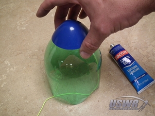 Cover the hole in the tip of the nosecone with a cap which you can cut from a plastic egg or ball and use glue to secure it in place.
