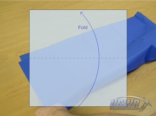 The first fold takes the bottom edge and folds it to the top edge of the square.