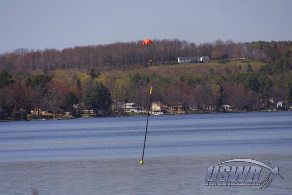 The X-12 Water Rocket from U.S. Water Rockets is shown here making a soft landing, using a cross-form parachute.
