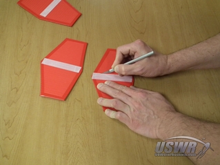 Score the fins on either side of the velcro strip to create a "living hinge".