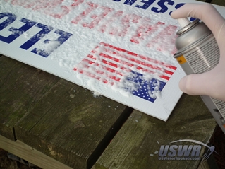 Apply paint stripper to the printed areas of the signs following the directions on the container.