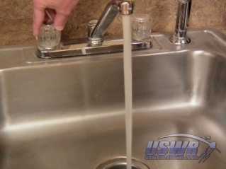 Turn hot water tap on in sink.