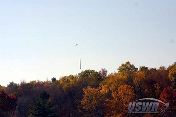 X-10 parachuting to a safe landing in front of beautiful Autumn colors..